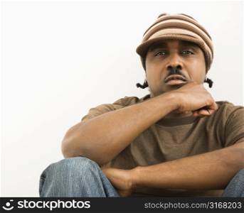 African-American mid-adult man wearing hat looking at viewer.