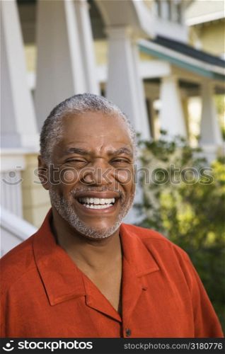 African American middle aged man smiling at viewer.