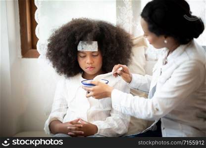 African American people, Mother is taking care of a sick daughter
