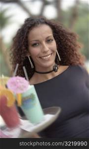 African American Waitress Carrying Tray of Tropical Drinks