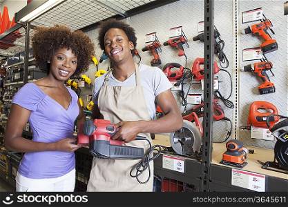 African American woman buying tool at hardware store