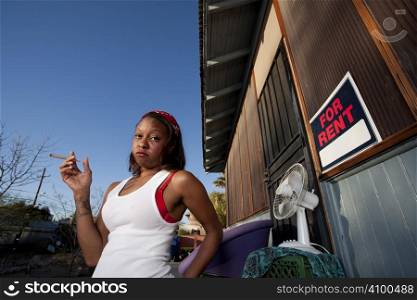 African-American woman in front of rental house