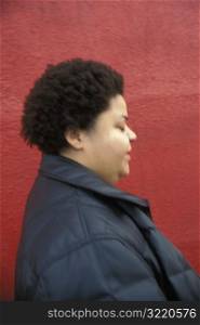 African-American Woman Standing Against Red Wall