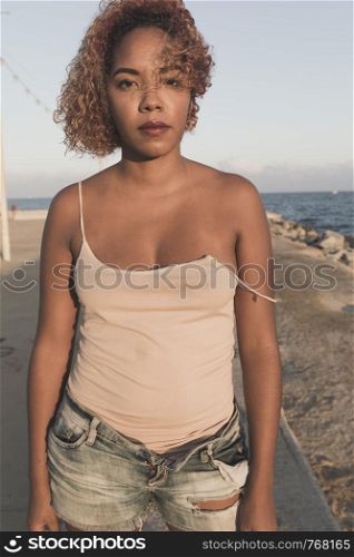 African American woman standup in shorts at Barcelona Beach
