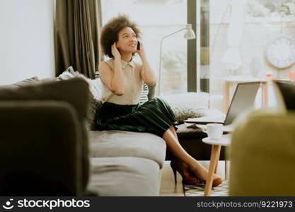 African american woman using mobile phone in the room at home