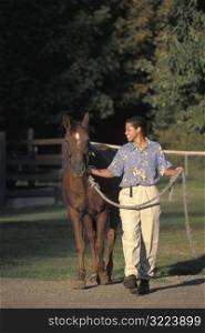 African American Woman Walking A Horse