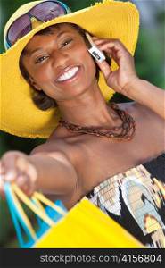African American Woman With Fashion Shopping Bags on Cell Phone