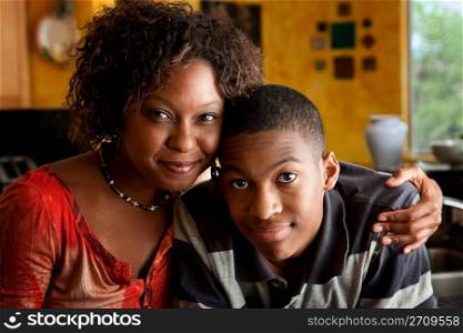 African-American woman with young man in kitchen
