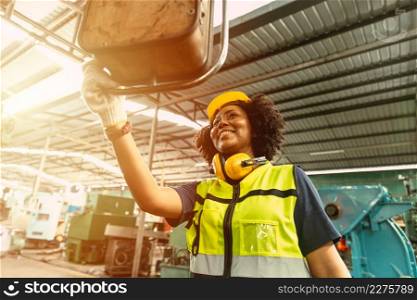 African American woman worker happy smiling working operate machine in heavy industry factory