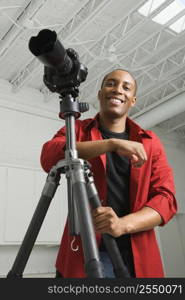 African American young male adult looking at viewer smiling.