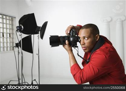 African American young male adult photographing in studio.