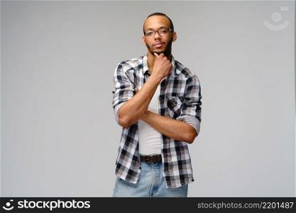 african-american young man wearing casual shirt over light grey background.. african-american young man wearing casual shirt over light grey background