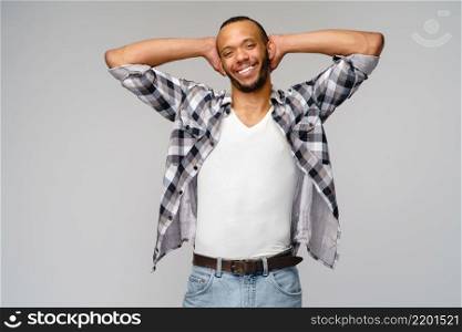 african-american young man wearing casual shirt over light grey background.. african-american young man wearing casual shirt over light grey background