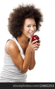 African American young woman holding and eating an apple