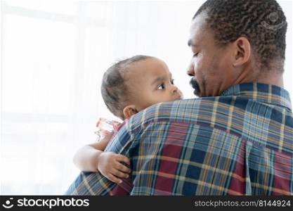 African bearded father carrying newborn baby on shoulder. Caring single dad holding little child daughter in arms and looking at his kid with love and care. White background