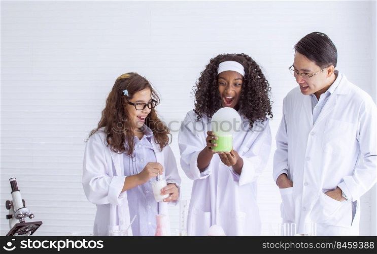 African black and caucasian girls studying science and making experiment in laboratory at school. Education and Diversity Concept.