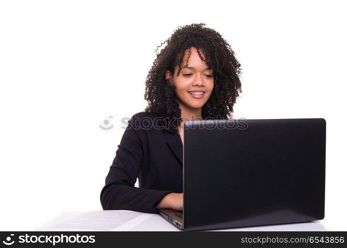 African business woman at work. Young african business woman working with a laptop pc, isolated over white