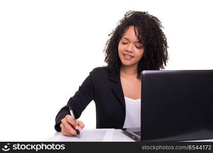 African business woman at work. Young african business woman working with a laptop pc, isolated over white