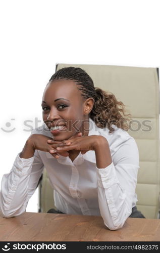 African business woman sitting at her desk and smiling isolated on white background