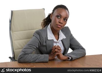 African business woman sitting at her desk and thinking isolated on white background