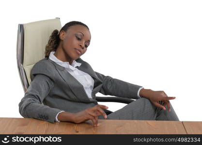 African business woman sitting at her desk and thinking isolated on white background