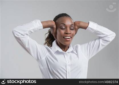 African business woman stretching and relaxing after long working hours, closing her ears