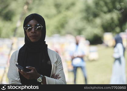 african  business woman using smart phone wearing traditional islamic clothes