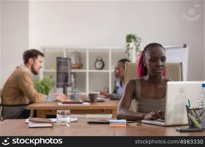 African business woman working in office environment using laptop