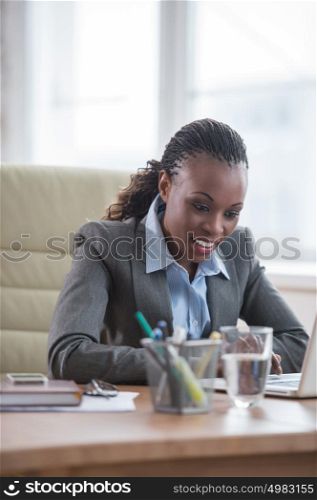 African Business woman working using laptop computer in office