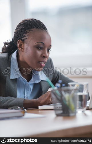 African Business woman working using laptop computer in office