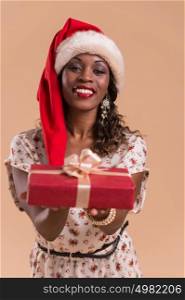 African Christmas woman wearing Santa Claus hat holding gift
