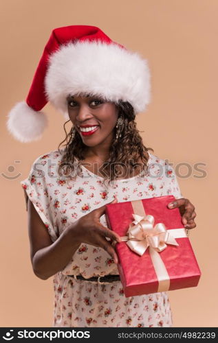 African Christmas woman wearing Santa Claus hat holding gift