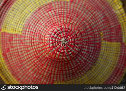 African conical shape colorful hat yellow and red macro texture