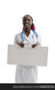 African doctor woman holding blank copyspace card board, concept of advertisement product, empty copy space, wearing white medical suit with stethoscope. Isolated over white background