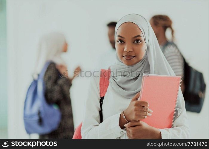 African female student with a group of friends in the background wearing traditional Islamic hijab clothes. Selective focus. High-quality photo. African female student with group of friends in background wearing traditional Islamic hijab clothes. Selectve focus 