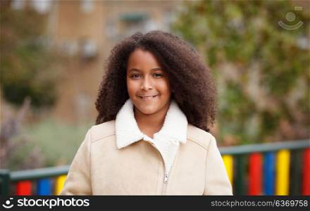African girl with a beautiful hair in a park