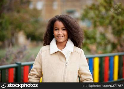 African girl with a beautiful hair in a park