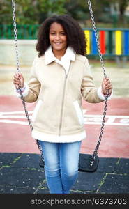 African girl with a beautiful hair in a park