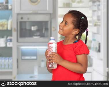 African little girl with water bottle in the kitchen