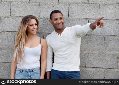 African man and caucasian girl. Young happy couple at outside