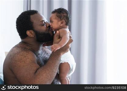African middle aged bearded father kissing while carrying and soothing newborn baby crying in his arms and hands in bedroom at home. Single dad try to pacify cute infant alone. Family bonding concept