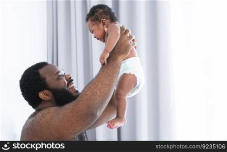 African middle aged bearded father smiling, carrying and soothing newborn baby crying in his arms and hands in bedroom at home. Single dad try to pacify cute infant alone. Family bonding concept