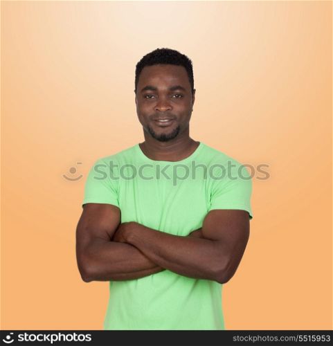 African muscled man isolated on a over a orange background