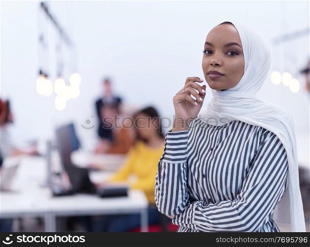 african muslim businesswoman portrait  wearing hijab at creative modern startup coworking open space office