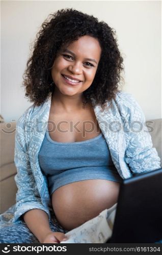 African pregnant woman shopping online for her baby
