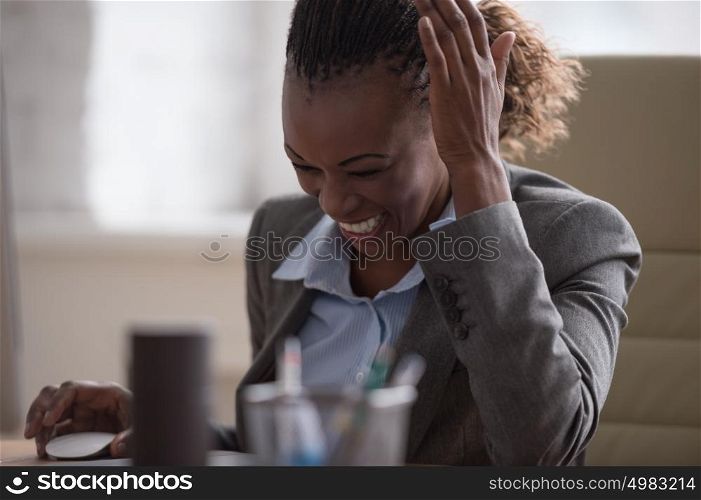 African pretty business woman working at pc in office