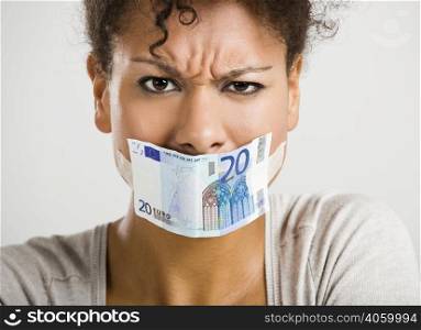 African woman covering her mouth with a euro banknote, great concept for the global crises