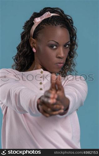 African woman making pistol gesture from her hands and shooting