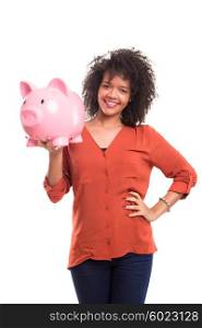 African woman putting some money into a piggy bank