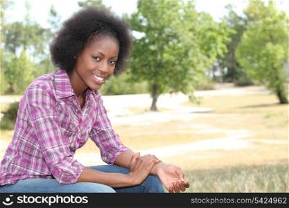 African woman relaxing in the park